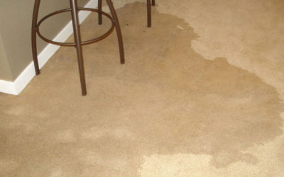 A dirty floor with water on it and a chair