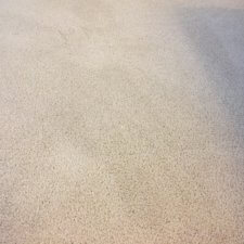 A white carpet with some stains on it